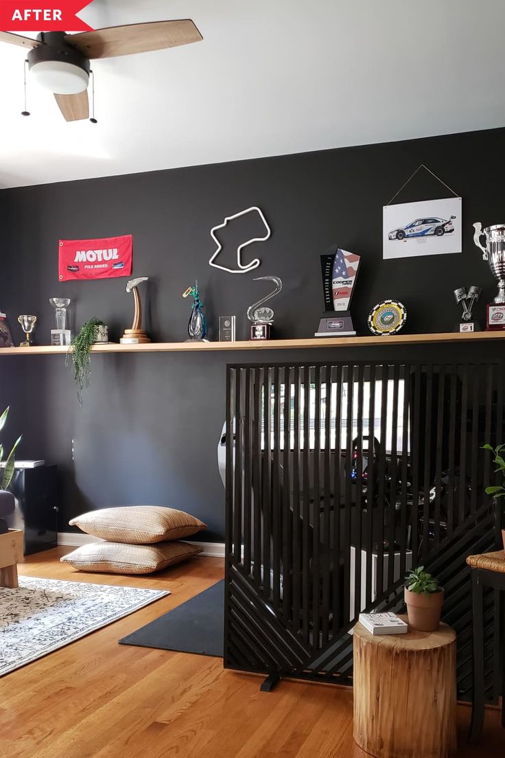 a living room with black walls and wooden floors