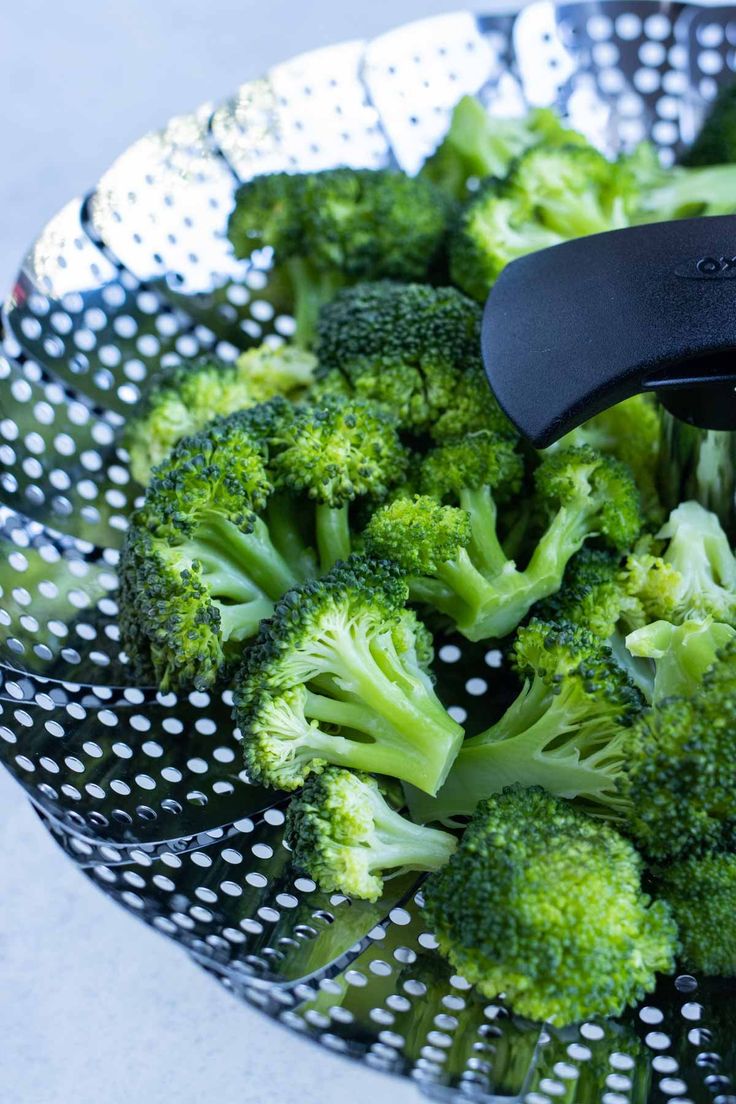 the broccoli is being cut into pieces with a large knife in it's center