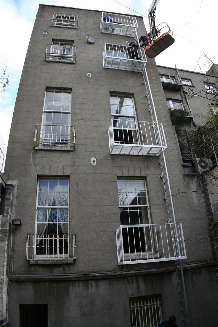 an apartment building with several balconies and windows