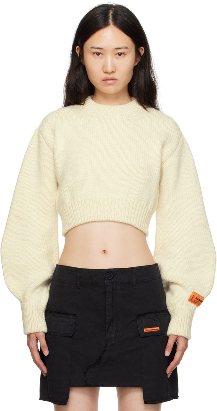 Knit wool sweater. · Rib knit crewneck, hem, and cuffs · Cropped hem · Bishop sleeves · Logo patch at sleeve · Cutout at back Supplier color: White Sleeve Crop Sweater, White Cropped Sweater, Heron Preston, Sweater Jumper, Knit Crewneck, Yellow Fashion, White Crop, Knit Jumper, White Sweaters