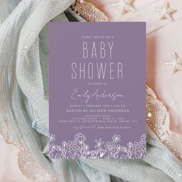 a baby shower is shown with purple and white flowers on the bottom, and silver stars in the background