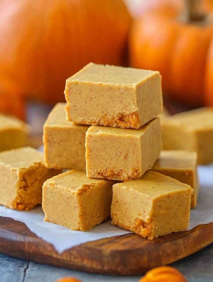 several pieces of pumpkin fudge sitting on top of a cutting board