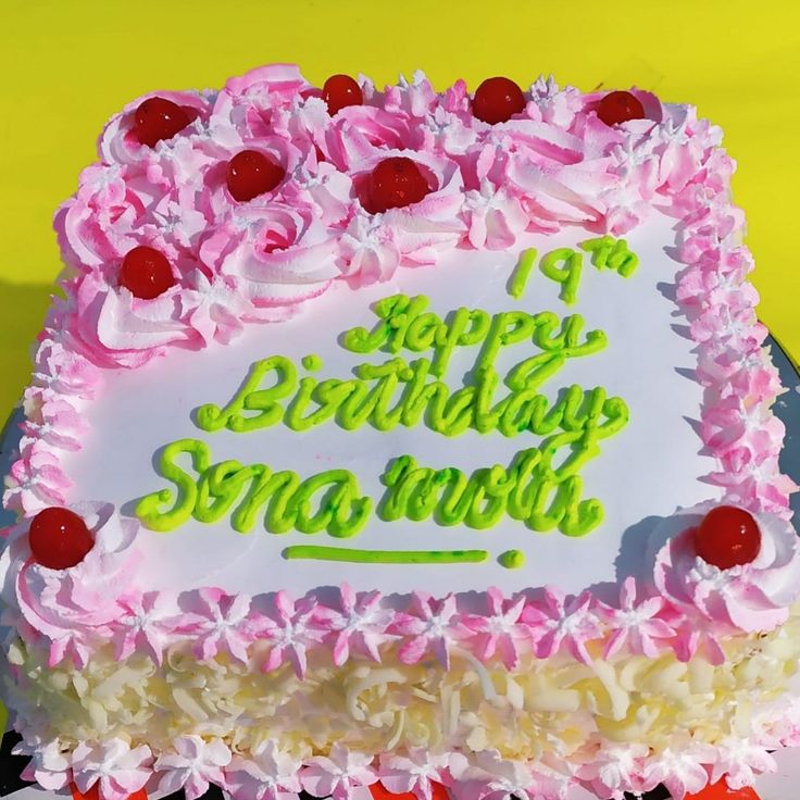 a birthday cake with pink and white frosting