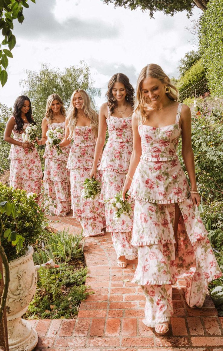 the bridesmaids are wearing matching floral dresses