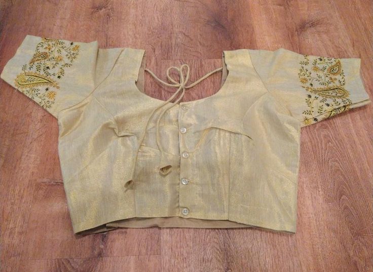 A pretty choli blouse in light gold soft tissue cotton with contrasting designs embroidered on the sleeves.  A choli is basically an Indian version of a crop top, traditionally worn with a saree or skirt but can also be paired with jeans or however suits you.  It has lining, is button up, has tie strings with pretty tassels at the back and short sleeves. It is available in size medium, which fits a 37-38 inch bust - with a few inches inseam - enough to adjust it up a little bigger should you need.  Please note that due to the nature of digital photography the colors may vary slightly in that they may be more vibrant or muted than the image. Cotton Saree Blouse, Choli Blouse, Silver Spring, Cotton Saree, Saree Blouse, Digital Photography, Tassels, Button Up, Crop Top