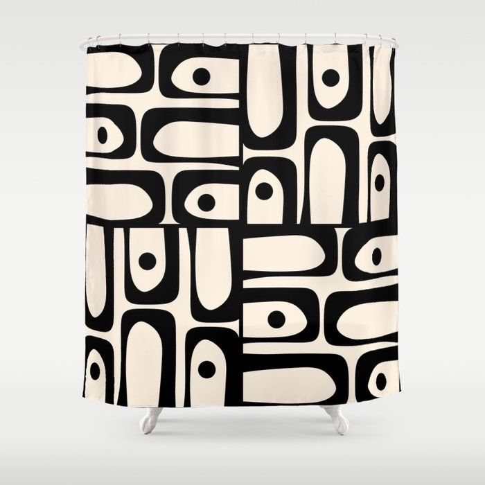 a black and white shower curtain with an abstract design on the front, featuring circles and rectangles