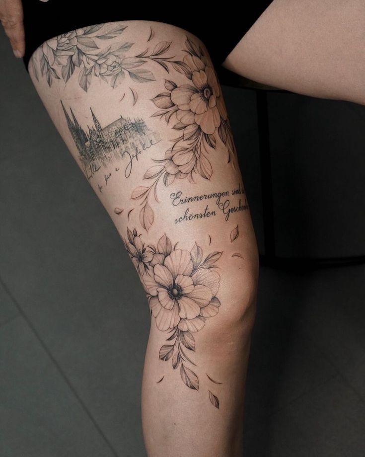 a woman's leg with flowers and words on it