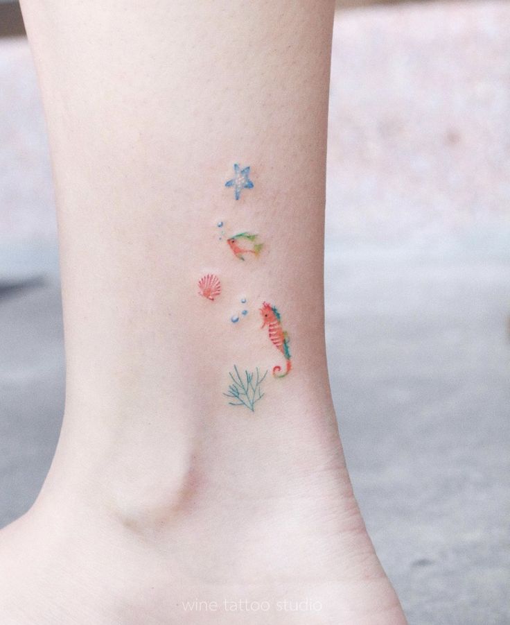 a woman's foot with small tattoos on the side of her body and flowers