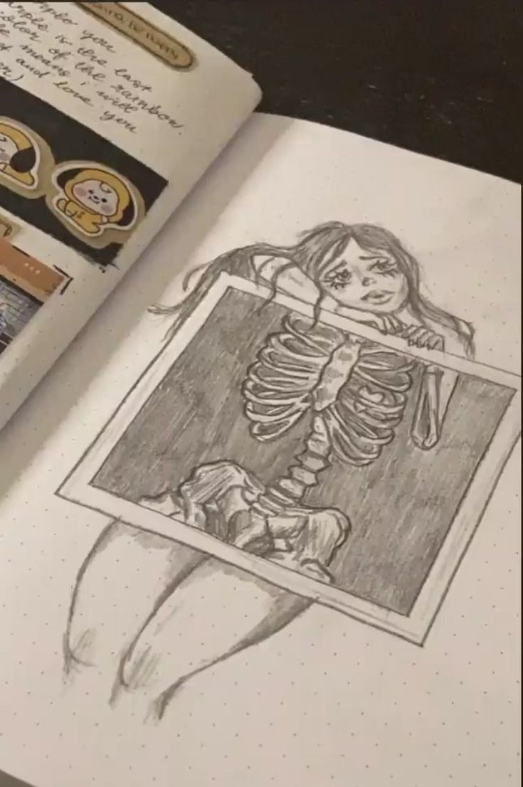 an open book with a drawing of a skeleton in it's corner and some stamps on the pages