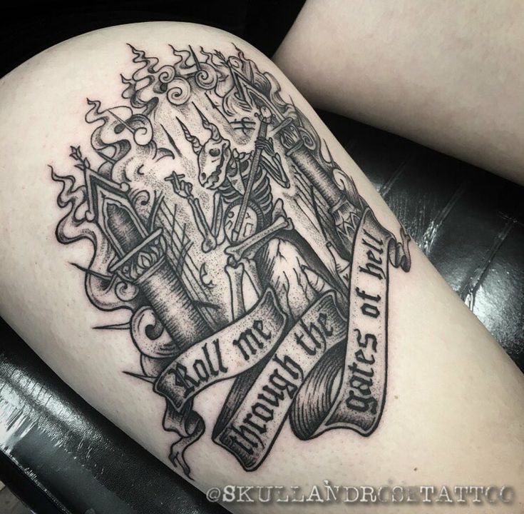 a tattoo on the leg of a woman with scissors and ribbon around her legs,