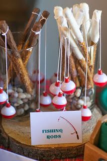 fishing rods are displayed in glass vases with paper tags on the top and below them