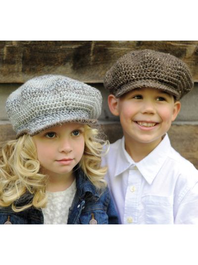 two children wearing knitted hats standing next to each other