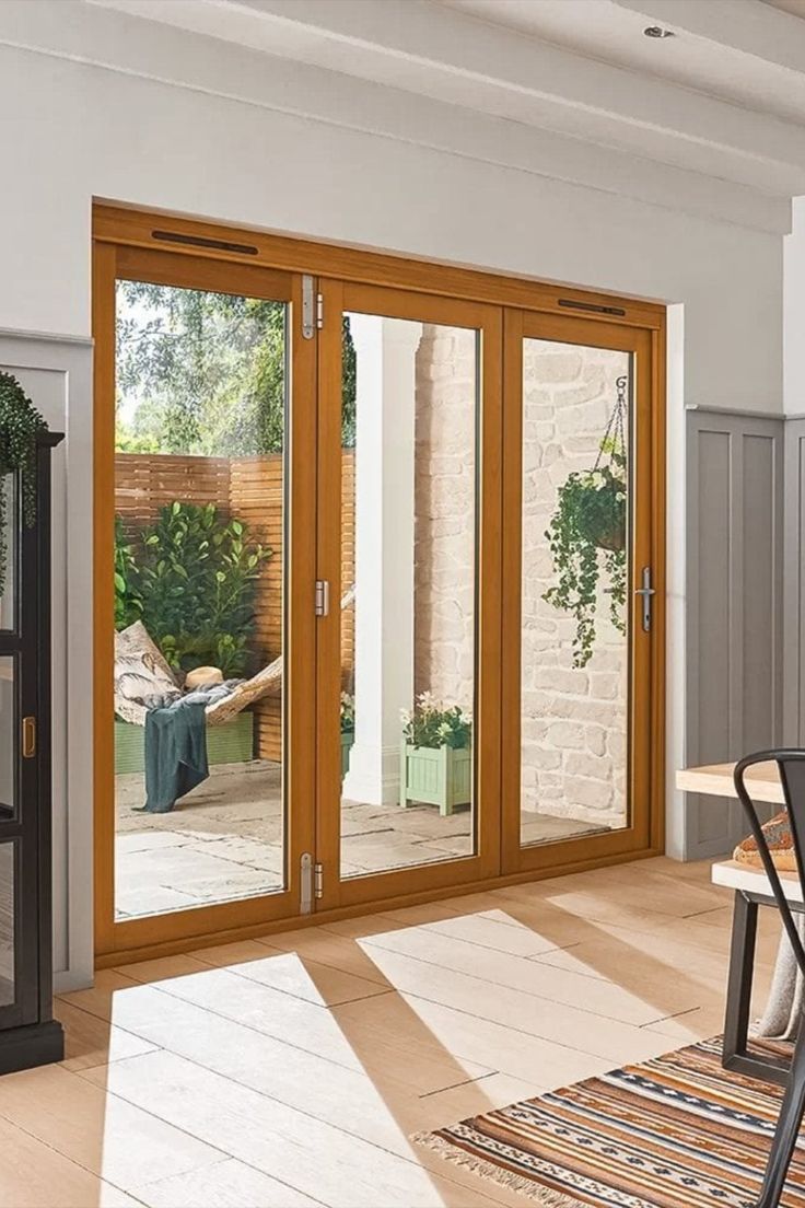 a dining room with sliding glass doors leading to an outside patio and sitting area in the background