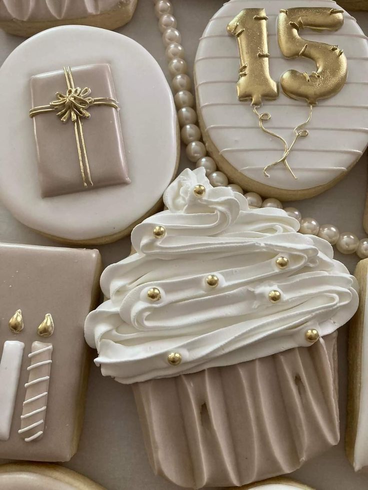 decorated cookies with white frosting and gold decorations