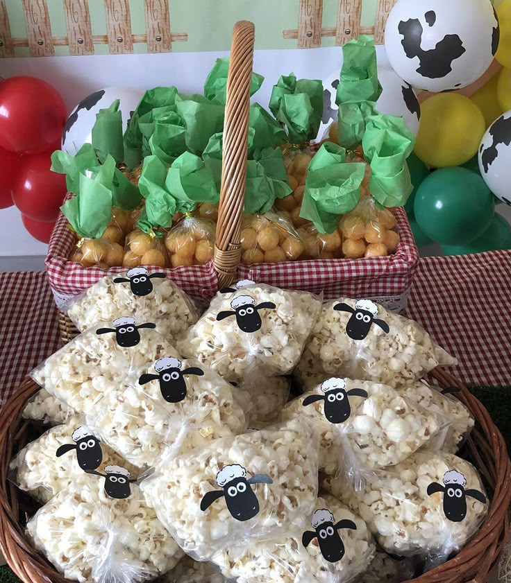 there are some rice krispy treats in a basket on the table next to balloons