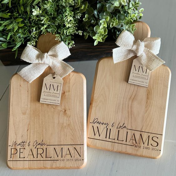 two personalized wooden cutting boards with tags on them