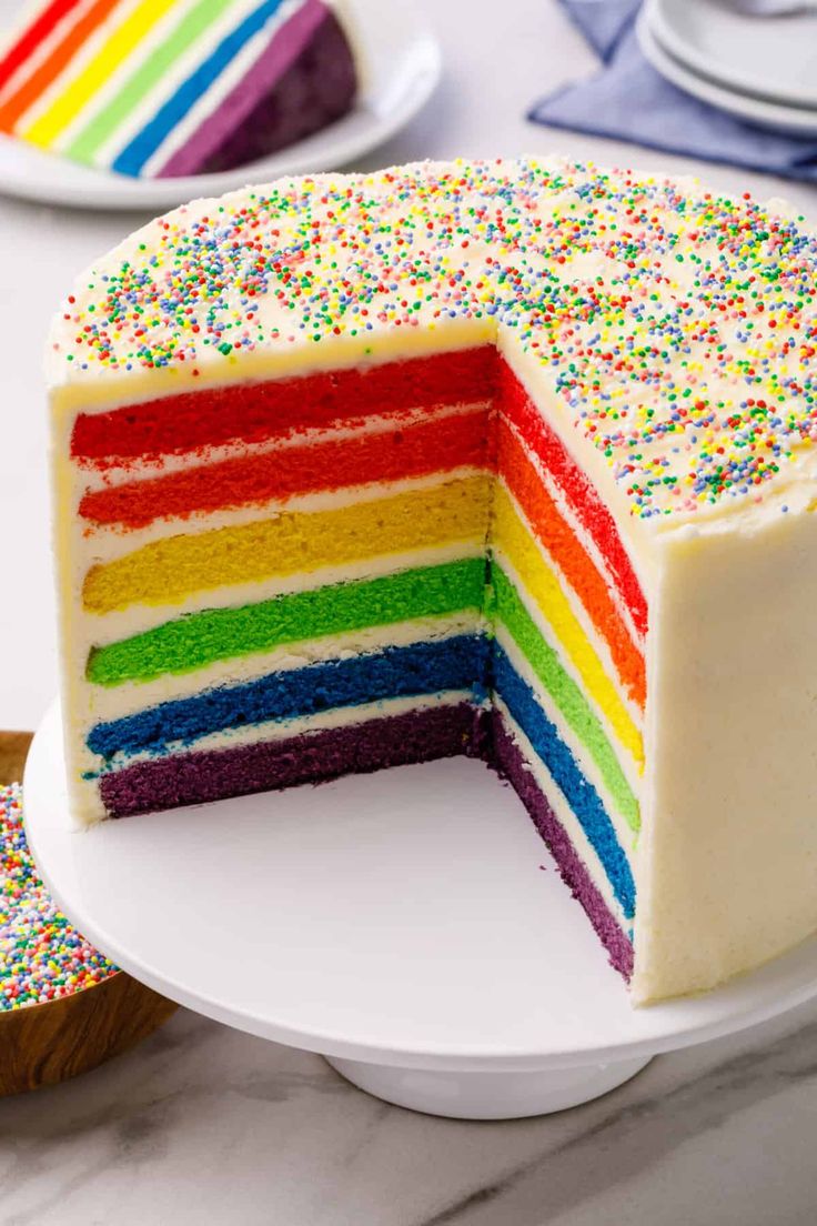 a rainbow cake with one slice cut out