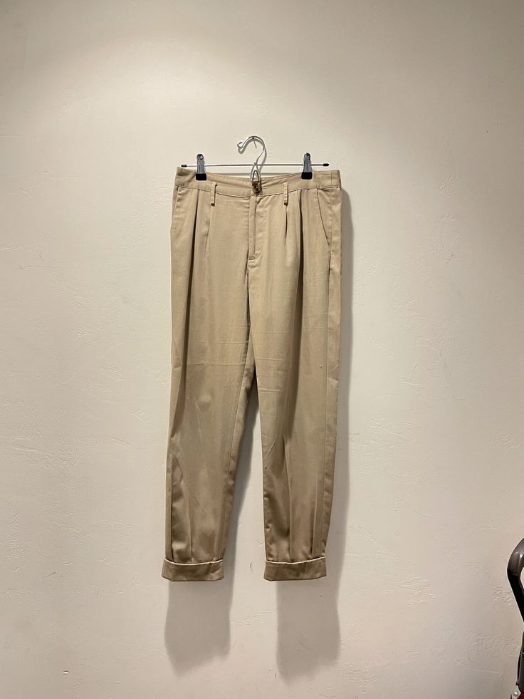 "Tan slacks with pleated details.  Waist: 15\" Rise: 10.5\" Length: 37\"" Classic Pleated Summer Pants, Summer Classic Pleated Pants, Classic Summer Pleated Pants, Summer Formal Pleated Pants, Pleated Tapered Leg Bottoms For Fall, Classic Stretch Pleated Bottoms, Classic Pleated Stretch Bottoms, Fall Pleated Tapered Leg Bottoms, Summer Pleated Tapered Leg Pants