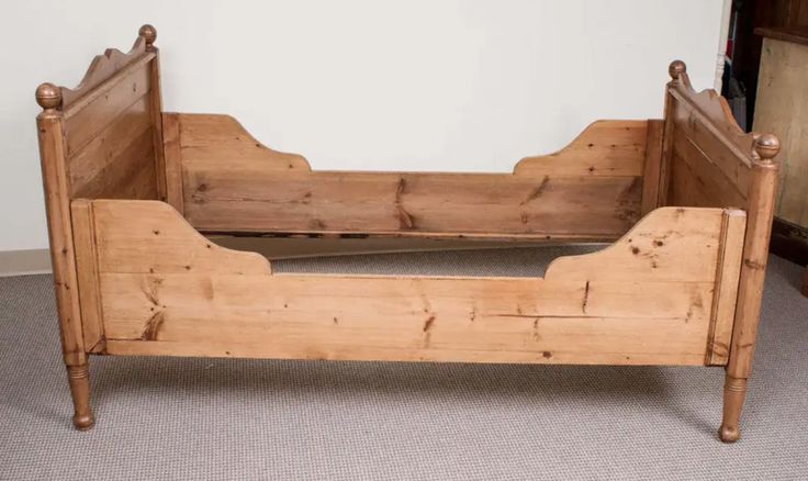 an old wooden bed frame sitting on the floor