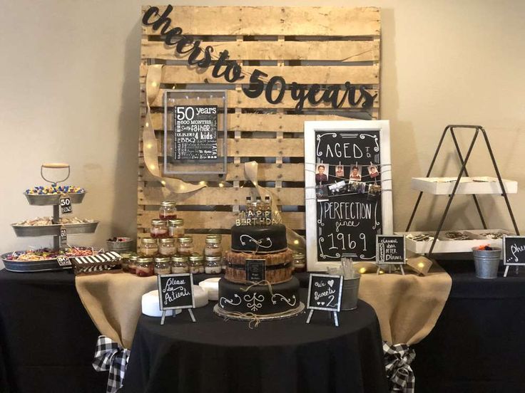 a table topped with lots of food next to a wooden sign that says it's gourmet