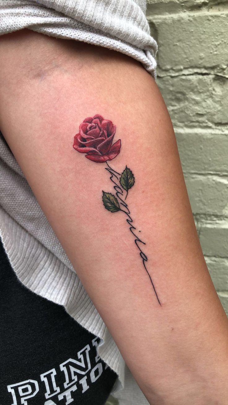 a rose tattoo on the left arm