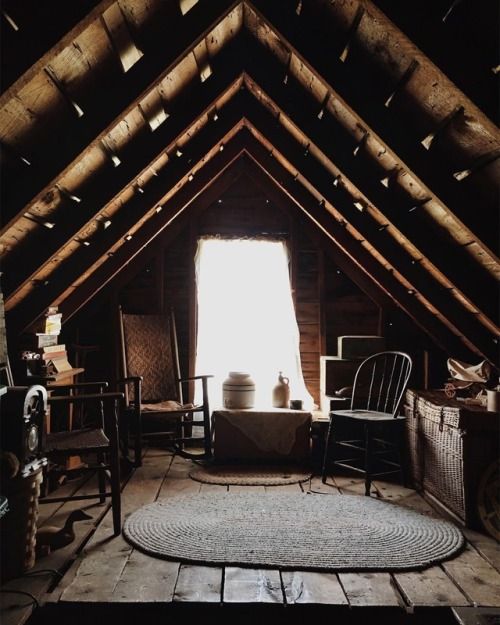 an attic with several chairs and tables in it