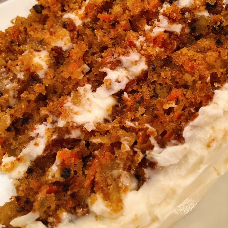 a piece of carrot cake with whipped cream on top