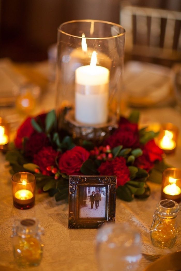 a table with candles and flowers on it