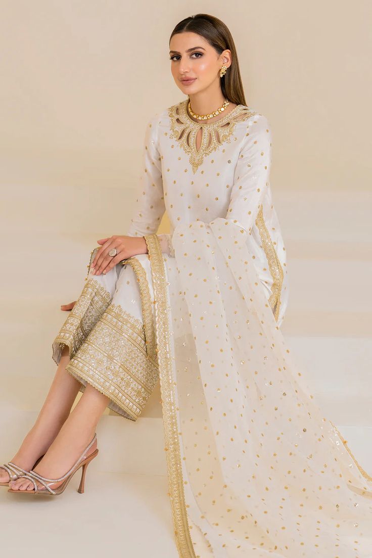 Indulge in luxury with this exquisite embroidered raw silk kurta pant set. The intricate embroidery adds a touch of elegance, making it perfect for any formal occasion. The versatile 3-piece set offers both comfort and sophistication in its stylish white color. Experience true quality and style with this set. 4 Piece (Top, Bottom, Dupatta, Inner) Shirt: embroidered korean raw silk trouser Trouser: embroidered korean raw silk trouser Embroidered organza dupatta Work: embroidered front, back & cho Phulkari Pants, Raw Silk Kurta, Lucknowi Kurta, Gharara Suits, Patiala Salwar Suits, Bridal Dupatta, Phulkari Dupatta, Chikankari Suits, Kurta Pant Set