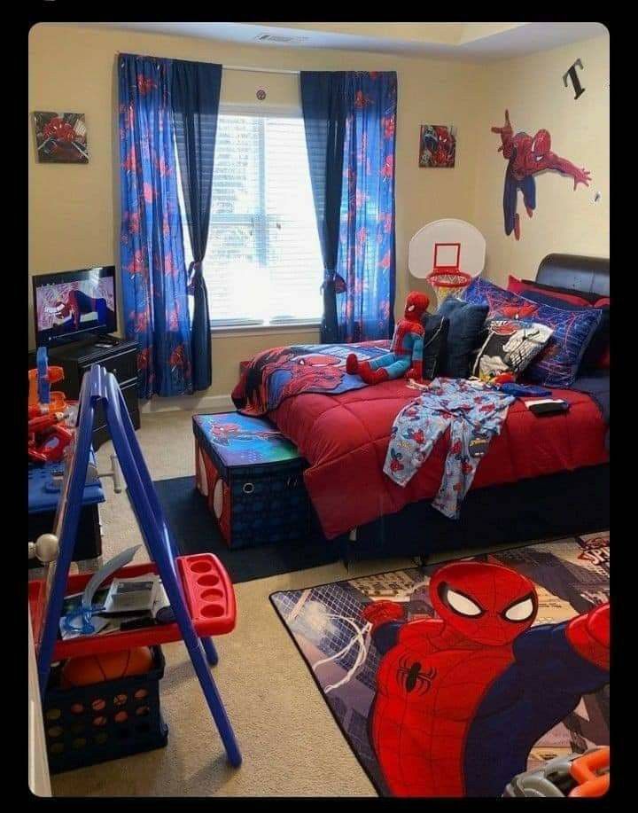 a bedroom with spiderman bedding and curtains