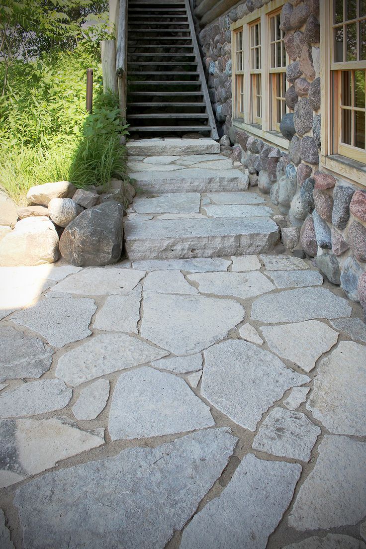 stone steps lead up to the front door of a house