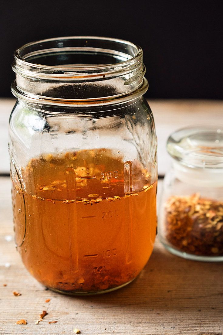 a jar filled with liquid sitting on top of a wooden table