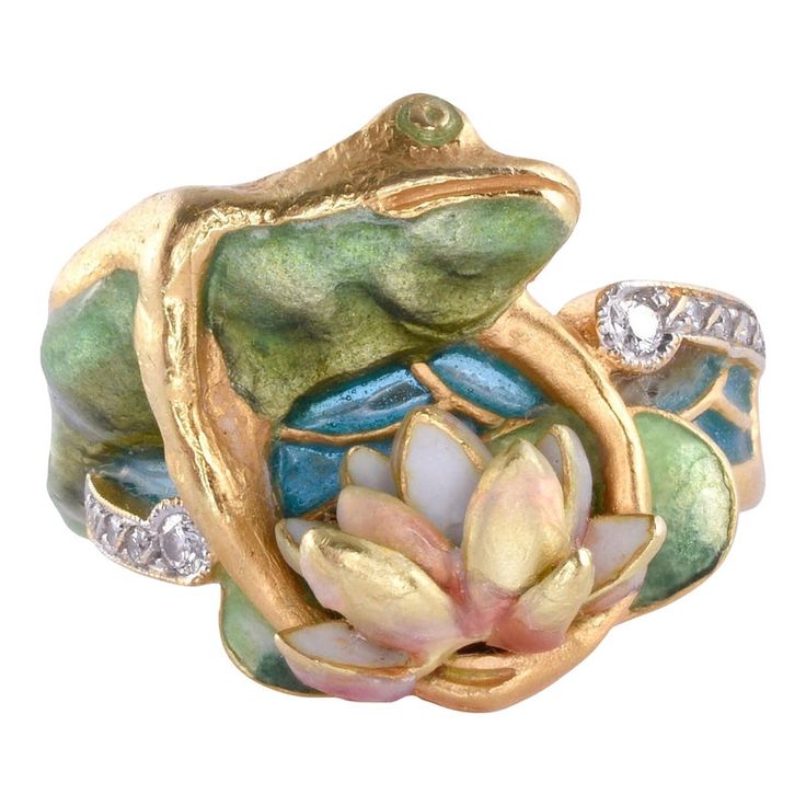 This is part of Chairish’s Fine Jewelry assortment.  Estate Masriera 18K enamel frog & water lily ring, circa 1980. This 18 karat yellow gold ring signed by Masriera features a frog and water lily design with full cut diamond accents at .08 carat total weight. The diamonds have VS1 clarity and F-G color. The Masriera ring showcases two types of fired enamel, basse taille & plique a jour water color enamel. Note some wear on the water lily. The ring is stamped C 3463 C. This enamel ring weighs 12 Water Lily Ring, Water Lily Design, Frog On Lily Pad, Plique A Jour, Frog Ring, Lily Ring, Frog Jewelry, Nouveau Jewelry, A Frog