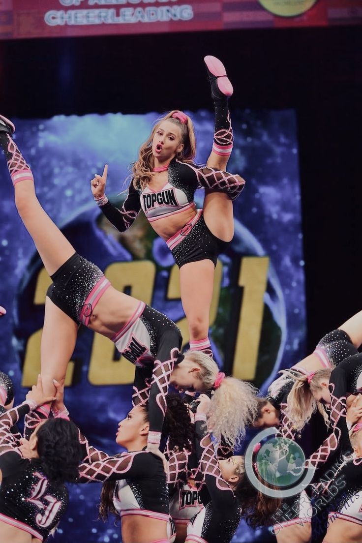 a group of cheerleaders performing in front of a crowd