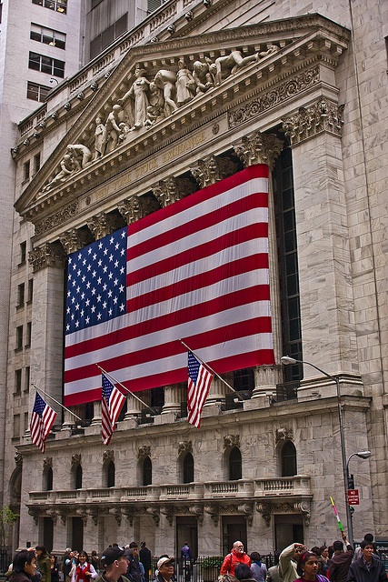 an american flag is displayed on the front of a building in new york city, ny