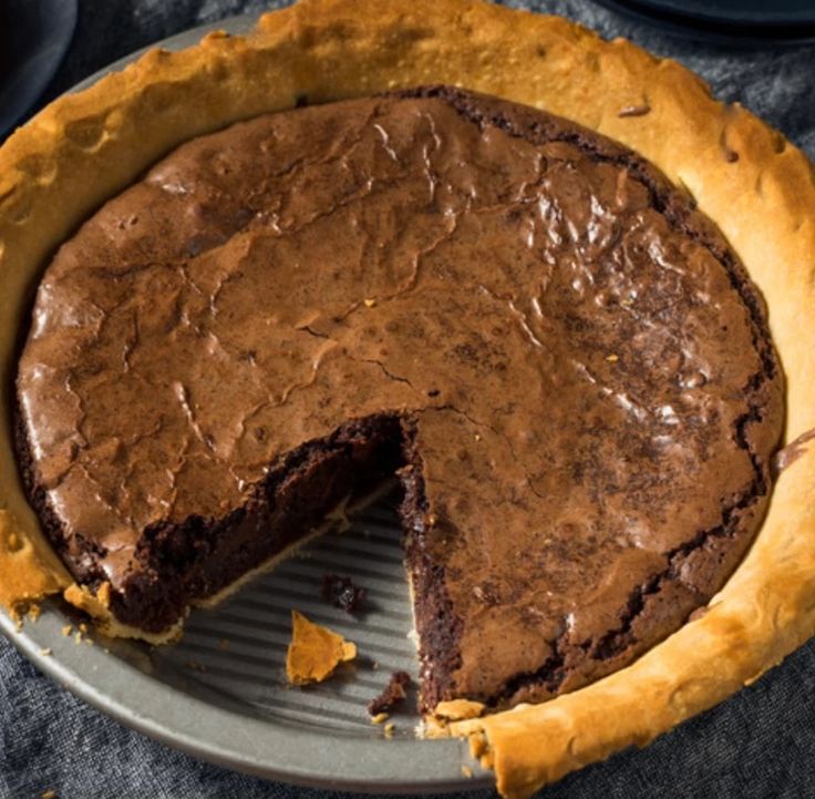 a chocolate pie with one slice missing from it