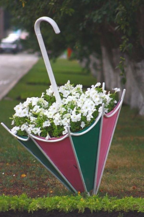 an umbrella shaped planter with flowers in it