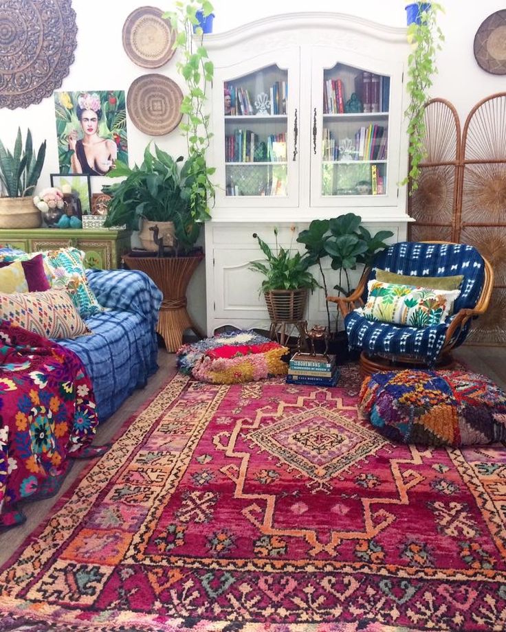 a living room filled with lots of furniture and rugs on top of a floor