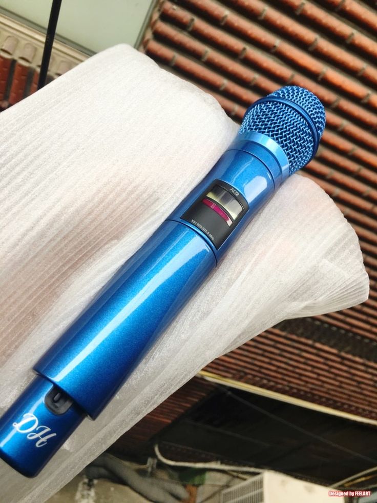 a blue microphone sitting on top of a white cloth