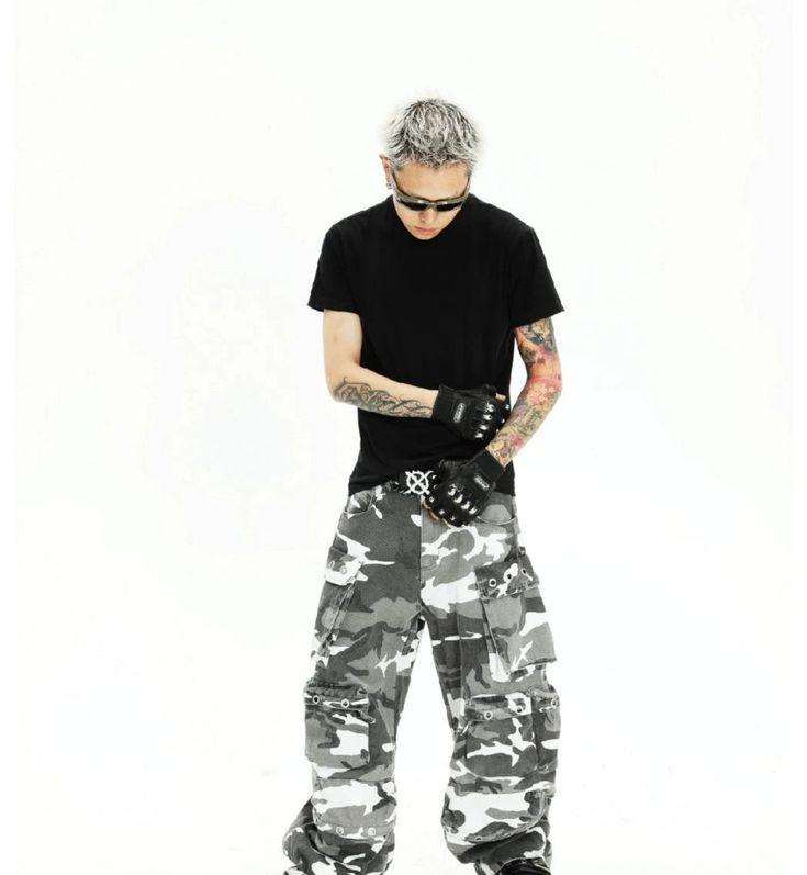 The Urban Camouflage Cargo Pants combine a modern camouflage print with a functional cargo design, perfect for adding a rugged and stylish edge to your wardrobe. Made from durable, high-quality fabric, these pants ensure comfort and longevity. The multiple cargo pockets provide ample storage and practicality, while the relaxed fit offers ease of movement. Fabric Information: 100% Pure Cotton Model's measurements: Height 180cm, Weight 65kg, wearing size L. Camouflage Techwear Pants For Outdoor Activities, Camouflage Techwear Pants For Outdoor, Techwear Camouflage Bottoms For Outdoor Activities, Combat Style Camouflage Bottoms For Streetwear, Camouflage Techwear Bottoms For Outdoor Activities, Combat Camouflage Cargo Pants For Outdoor Activities, Urban Camouflage Bottoms For Outdoor, Camouflage Utility Parachute Pants For Streetwear, Camouflage Parachute Pants With Multiple Pockets For Outdoor