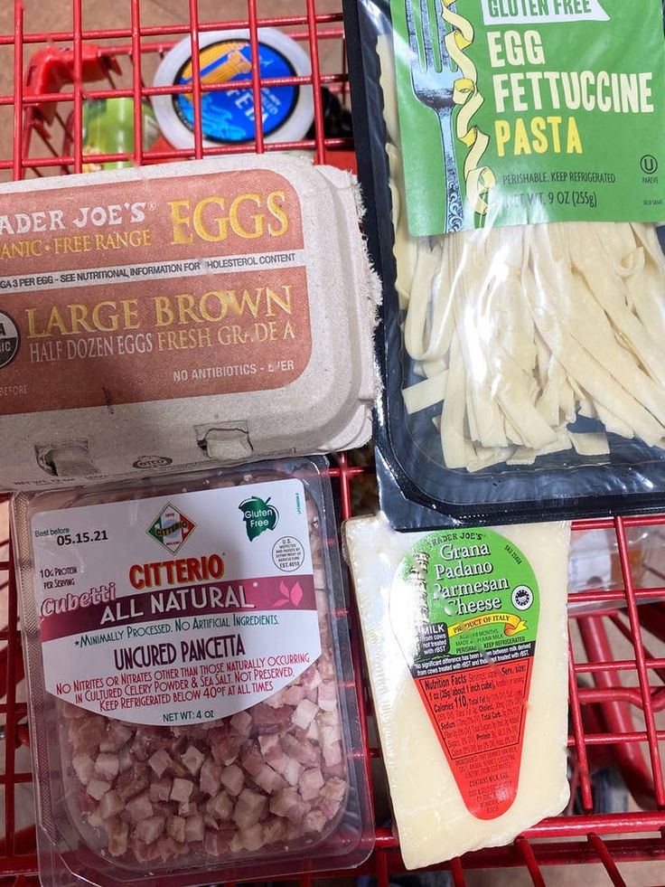 three packages of food are sitting in a shopping cart