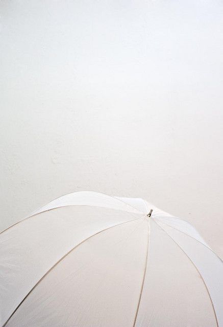 an open umbrella sitting on top of a sandy beach