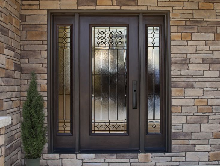 the front door to a home with two glass doors and sidelights on each side