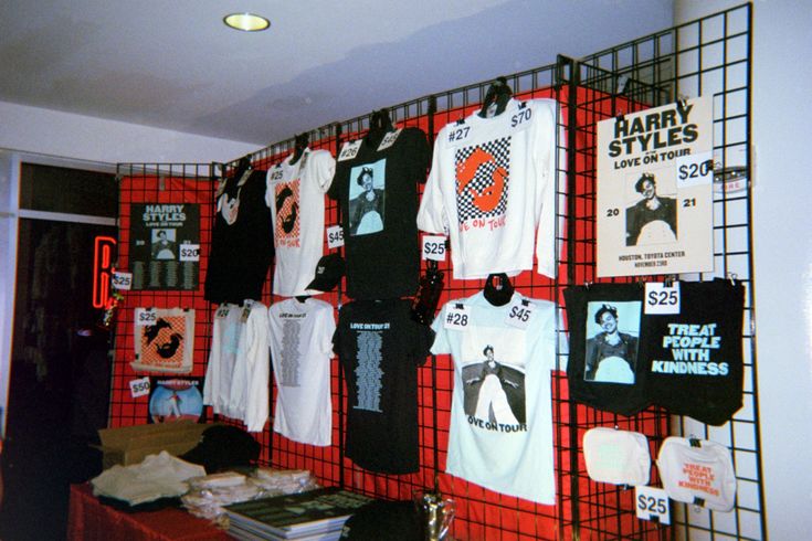 there are many t - shirts hanging on the wall