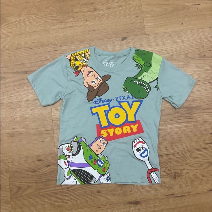 Toy Story Birthday Shirt Brand New Can Be Worn For Birthday Party Size: 5/6 Playful Tops With Funny Print For Playtime, Fun Blue Tops For Birthday, Disney Short Sleeve Top For Birthday, Playful Funny Print T-shirt For Playtime, Playful T-shirt With Funny Print For Playtime, Disney Green Tops With Character Print, Playtime Graphic Tee With Character Print, Graphic Tee With Character Print For Playtime, Playful Character Print Top For Birthday