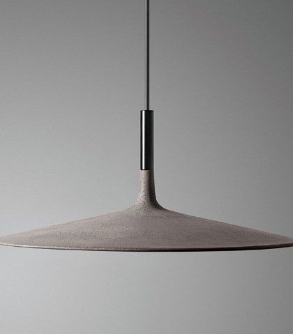 a light that is hanging from the ceiling in a room with gray walls and flooring