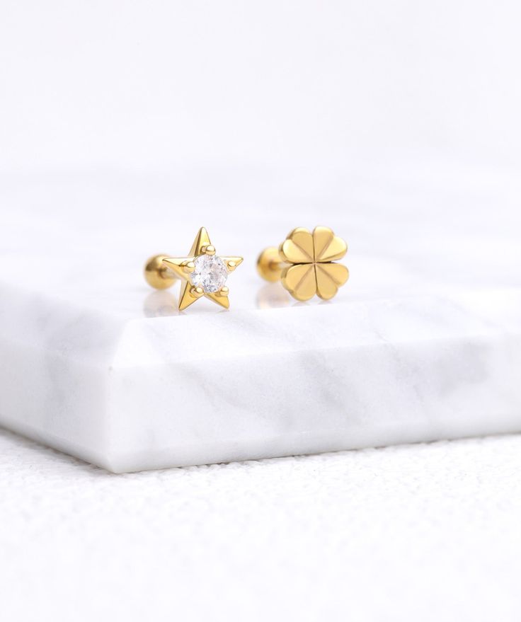 Introducing our Shining Star Stud earrings, perfect for adding a touch of cuteness to any outfit. Inspired by the starry sky, these earrings will add a touch of sophistication to your look. Be the shining star wherever you go. ✨ Detail： -Post material: gold plated with internal stainless steel or stainless steel. Cubic Zirconia -Gauge: 16g | 1.2mm-Post length: 6mm-Dimensions: 6.4mm Length x 6.7mm Width -Include: single item -Closure: screw ball back * Shop extra ball backing here. * Piercings ar Elegant Gold Cartilage Earrings With Star Charm, Elegant Gold Star Piercings, Elegant Star Charm Cartilage Earrings, Gold Dainty Star Cartilage Earrings, Gold Star-shaped Dainty Cartilage Earrings, Dainty Gold Star Cartilage Earrings, Elegant Star Shaped Cartilage Earrings With Star Charm, Gold Piercings With Star Charm As Gift, Elegant Gold Star Cartilage Earrings