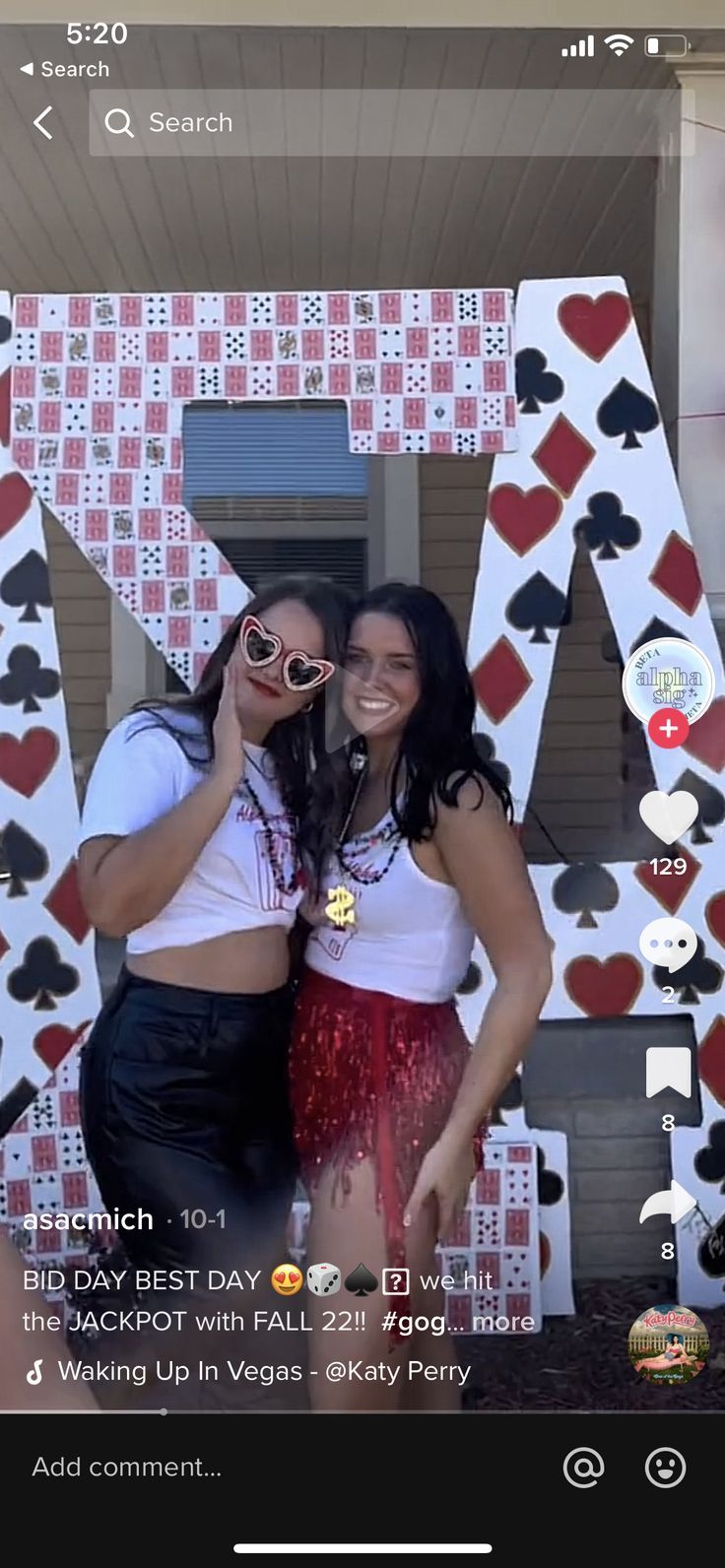 two women standing next to each other in front of a sign that says las vegas