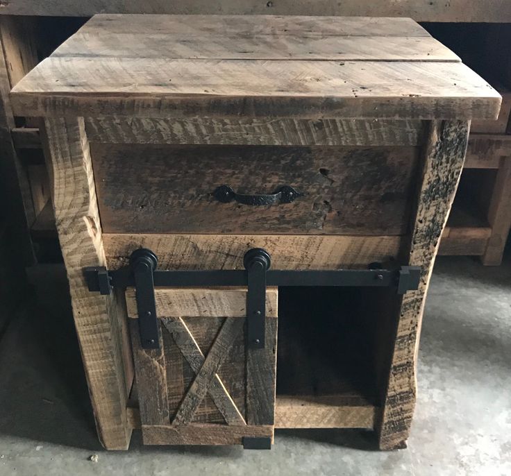 an old wooden table with two doors on the bottom and one door open to reveal a drawer