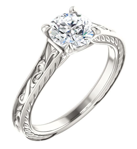 a diamond engagement ring with filigrees on the sides and an engraved band